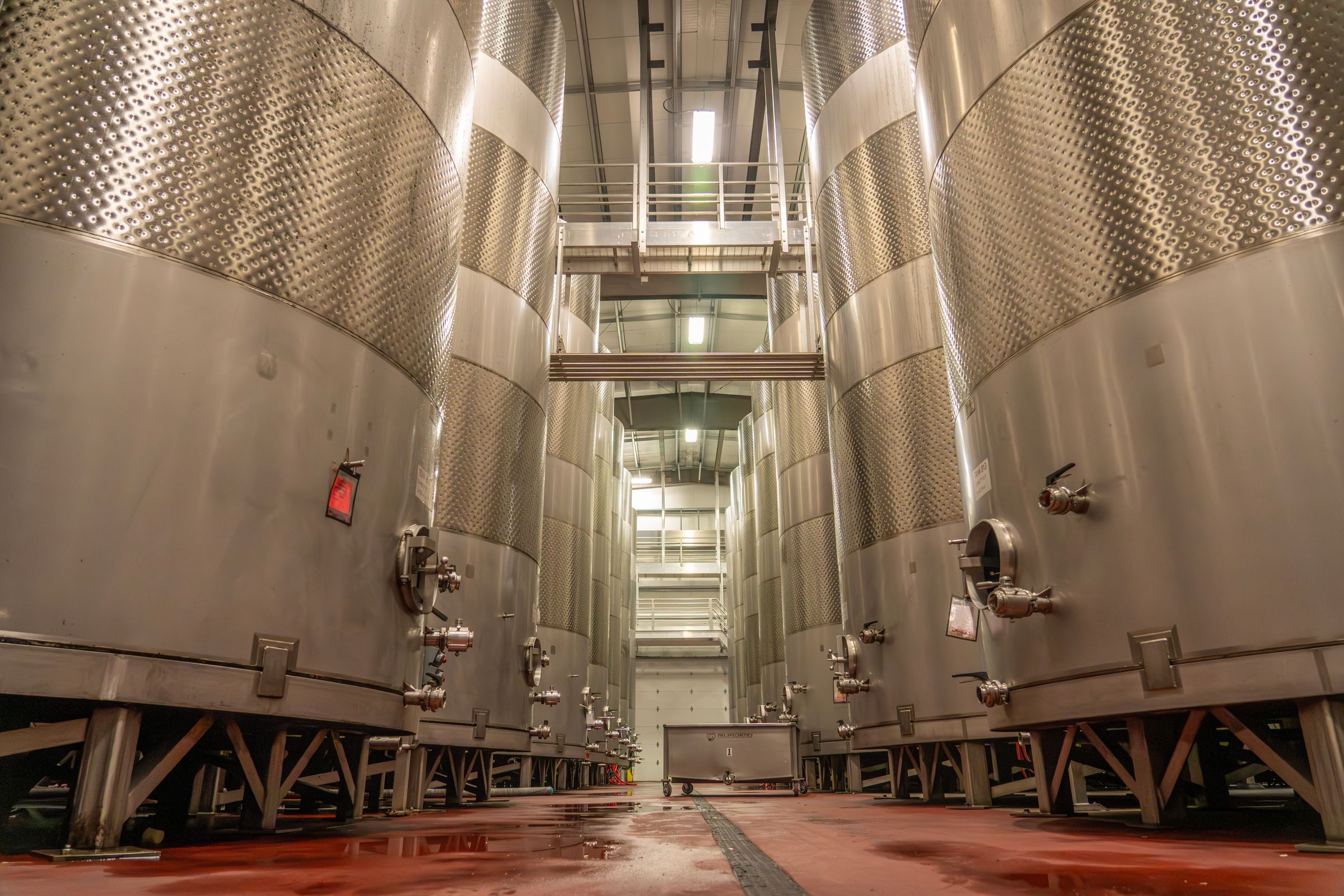 Stainless steel process vessels inside an industrial brewery